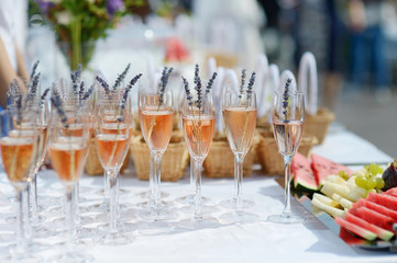 Custom cocktail menus and champagne towers in a luxurious wedding lounge setting.
