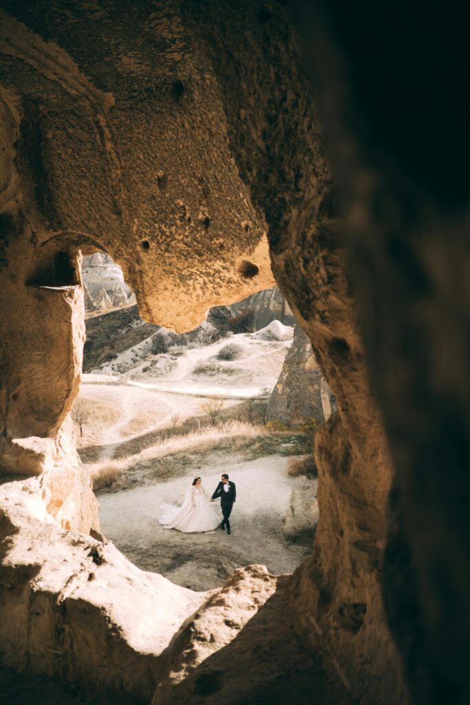 Couple walking down the aisle, with elegant lighting and cinematic focus by a professional cinematographer.
