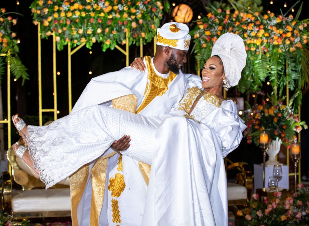 Couple participating in a traditional cultural ritual, surrounded by family and friends, showcasing the blending of their heritages