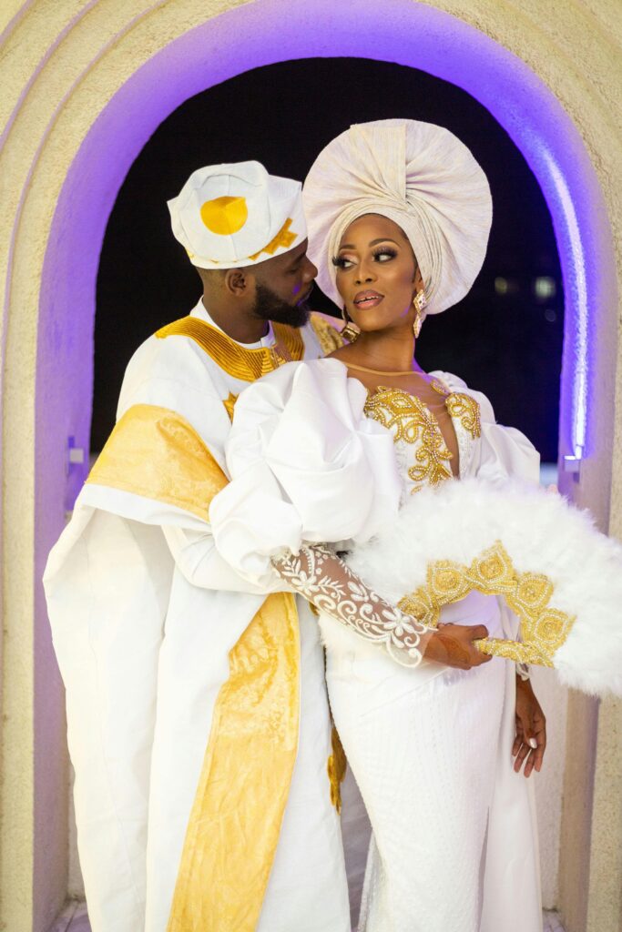 Guests at a multicultural wedding reception, enjoying a lively atmosphere with traditional music and dance, celebrating the couple's love.